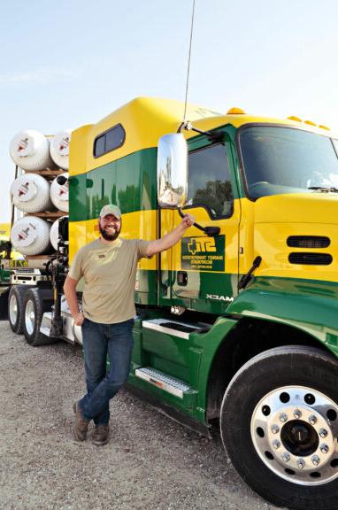 Mark Sanders in front of a semi truck that he learned to drive at JWCC.